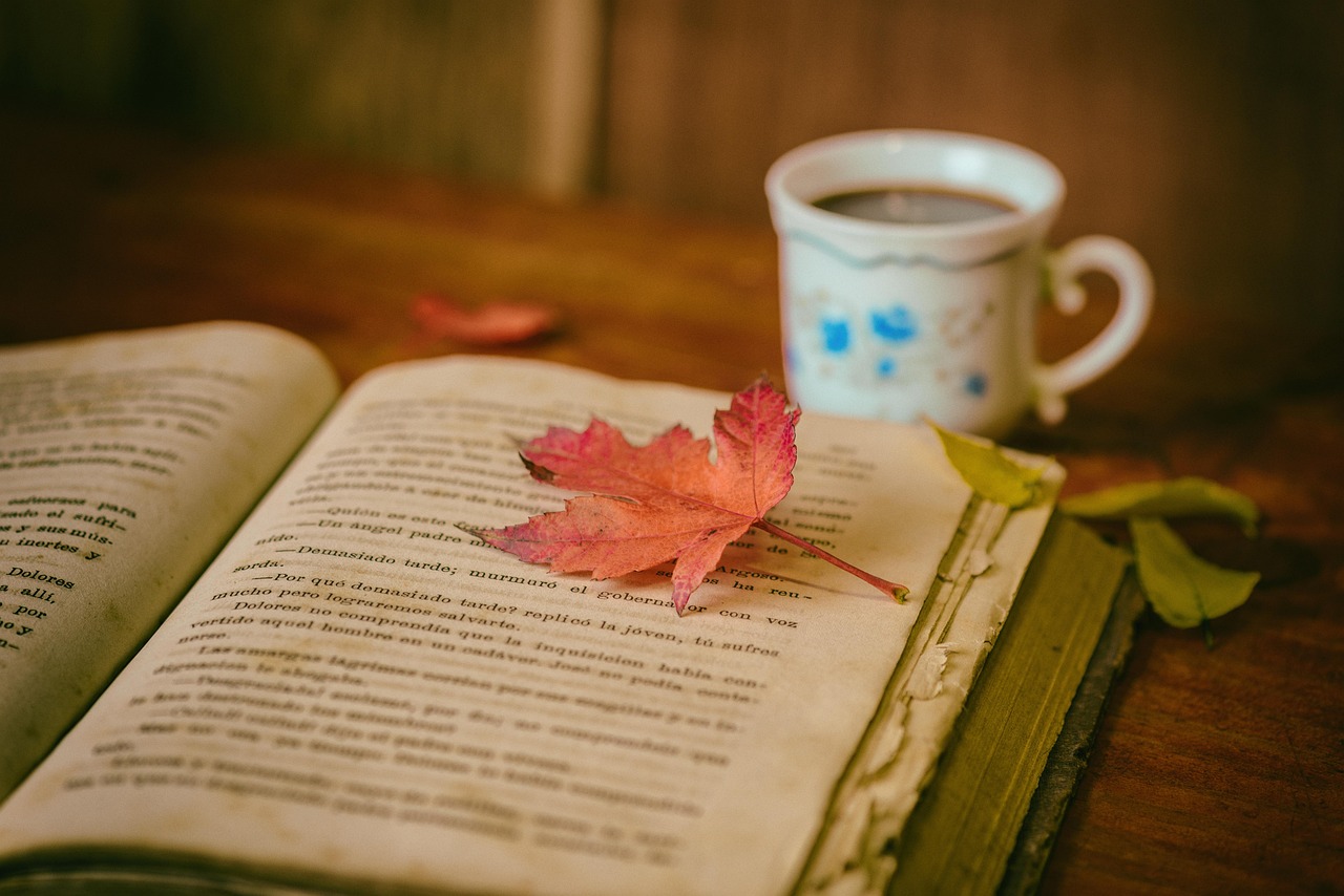 Open book with a warm cup of tea, representing reading and learning support